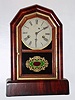 New Haven Clock Co., New Haven Conn. "Octagon Prize" 30 hour time and strike spring driven movement in mahogany veneer case, c1890
