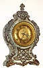 F. Kroeber Clock Co., New York "Moliere" mantel clock garniture set 8 day time and strike spring driven Eclipse movement in variegated enamel over iron case with cast metal appliquEs and painted brass dial with beveled glass, c1900 including unrestored matching candelabra