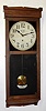 New Haven Clock Co., Conn., "No. 3043" 8-day time-only stained wood wall clock, C.1917.