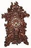 Emilan Wehrle and Co, Trumpeter Clock Factory, Furtwangen, Germany, shelf flute clock, 8 day time, strike and 9-tube flute playing spring driven movement with choice of two tunes. The profusely carved case decorated with deer, squirrels, leaves and acorns also has two carved and painted flautists appearing through doors, bottom of case front. The dial has outstanding and intricately carved bone hands and numerals, c1880