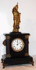 F. Kroeber Clock Co., New York, "Noiseless Rotary No. 4" mantel clock with 8 day time and strike spring driven movement in enameled cast iron case with marbleized columns and painted metal figure supporting rotary pendulum with bronzed ornaments, c1882. Note the statue holds a ball style pendulum that travels in a conical pattern, as it is driven by a rotating stud projecting upward from the movement. Kroeber and Briggs were the only two Americans known to utilize this French invention, and Terwilliger's versions were made in Germany.