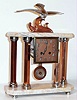 French Art Deco mantel clock with 8 day time and strike on bell spring driven movement in marble top and base case with bronzed pillars and surmounted by a bronze statue of a seagull signed "Decoux", c1925