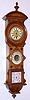 Junghans, German, wall clock with 8 day time only spring driven pendulum movement in walnut case with ornately inlaid decorations with mercury thermometer and aneroid barometer, c1900