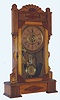 William L. Gilbert Clock Co., Winsted, Conn., C. 1885, "Calpe", 8-day time/strike/alarm ash and walnut mantel clock.