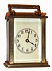 Waterbury Clock Co., Conn. "Speck", 30-hour carriage timepiece, brass case, ivory colored porcelain dial. C. 1910