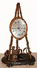 In the style of Thomas Cole, London, C.1850, figural group fitted with a French silk thread suspension movement. Gilt brass cast branches and an engraved silvered dial. Silvered cast figures.