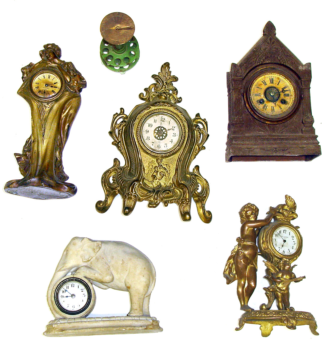 Six novelty timepieces. Includes mini pedestal sundial, Terry time/alarm architectural with rear paper label, Lux white elephant, Gilbert, New Haven, and Seth Thomas Nouveau. — Antique Clocks Price Guide