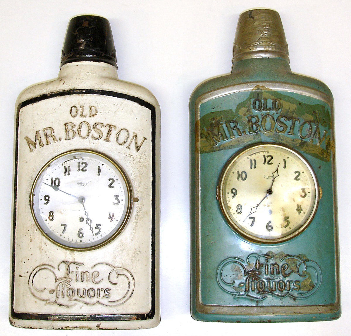 Two Gilbert "Old Mr. Boston" clocks. Green and white versions. Spring movements, time only, 21" tall. — Antique Clocks Price Guide