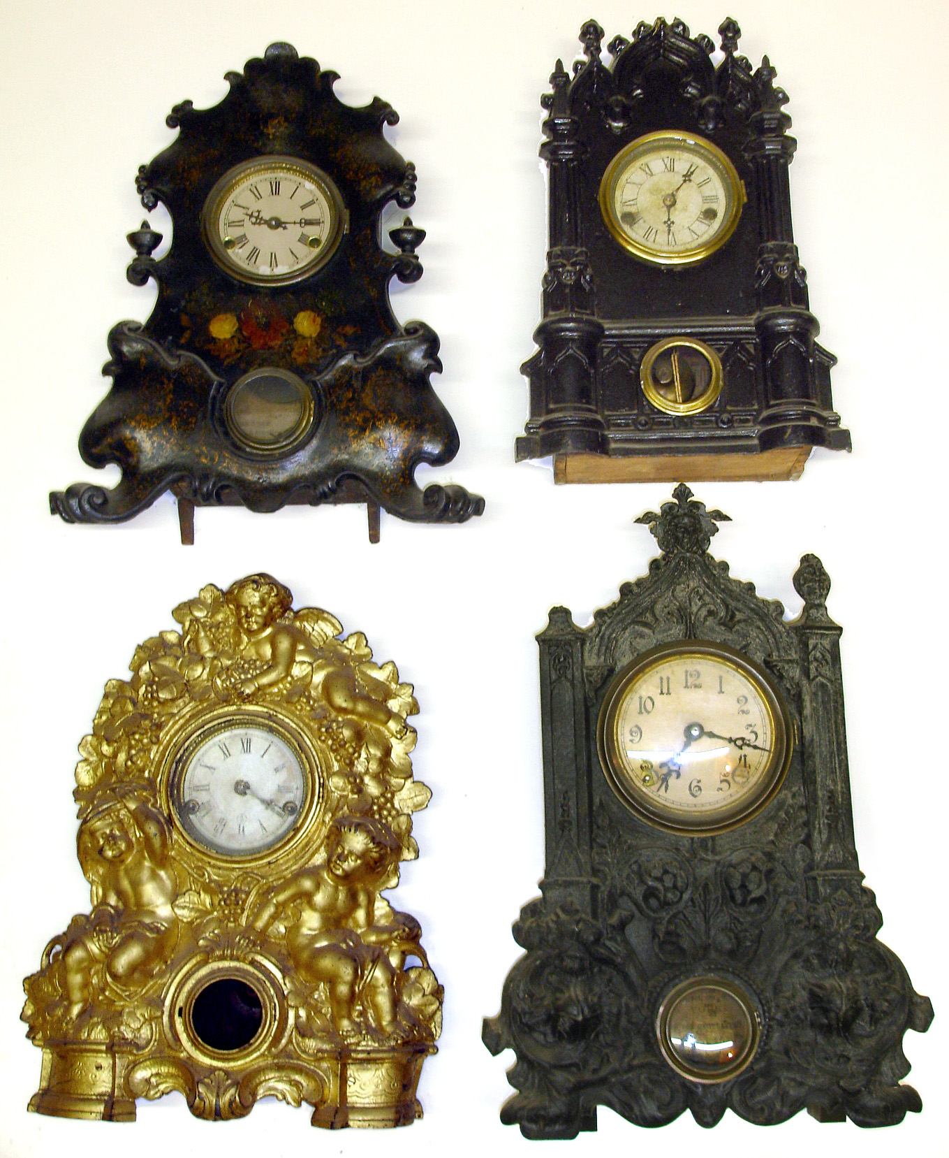 Four American iron fronts All with inside paper labels: Kutztown PA overpaste, American Clock Co., Crosby and Vosburgh and Nicholas Muller -- tallest at 19" high. — Antique Clocks Price Guide