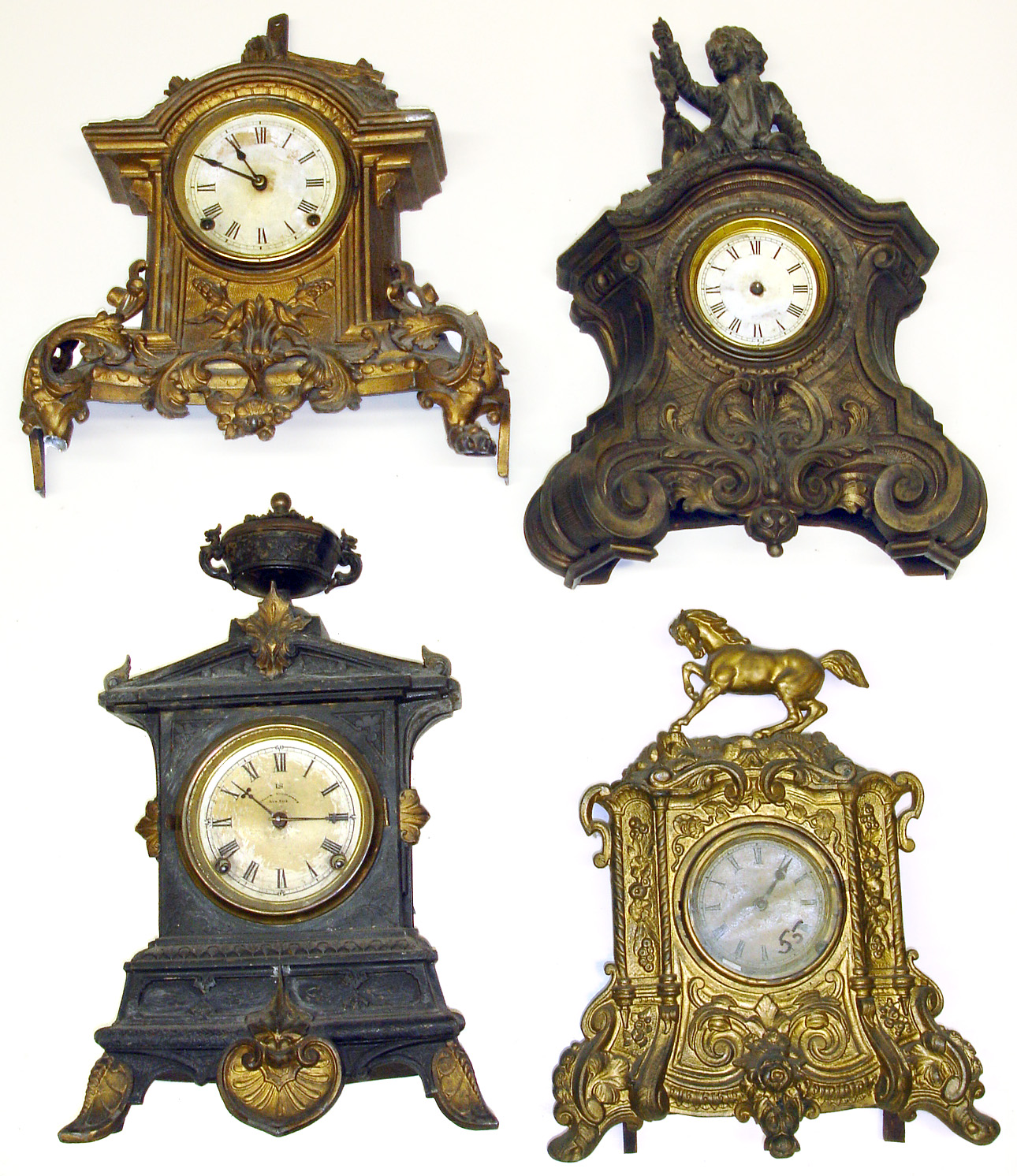 Four Connecticut 8-day cast-metal mantel clocks. Heavy detailed castings. Largest, with urn top and U.S. Clock Co. dial, is 19" high. — Antique Clocks Price Guide