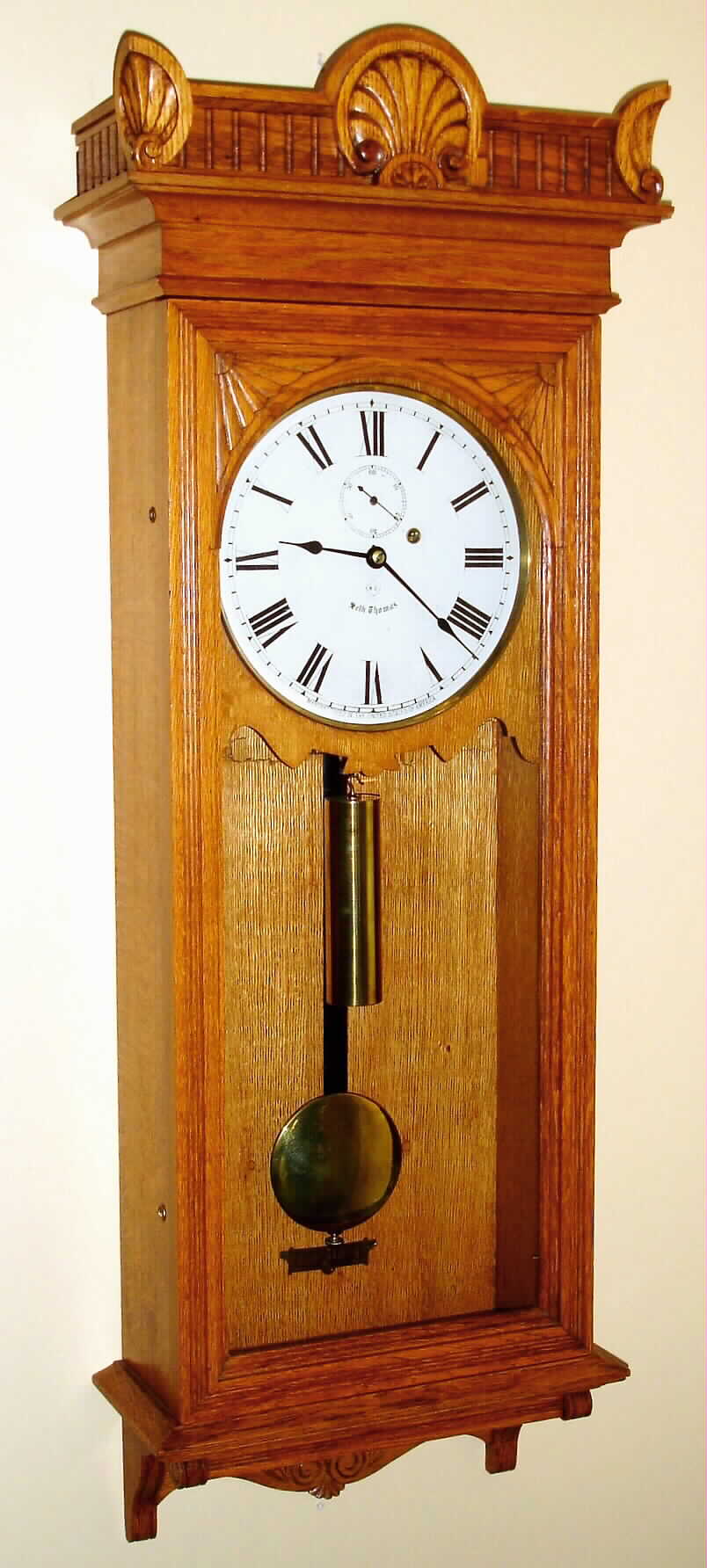 Seth Thomas Clock Co., Thomaston, Conn., "Regulator No. 9" wall clock 8 day time only weight driven movement in oak case with painted metal dial, c1900 — Antique Clocks Price Guide