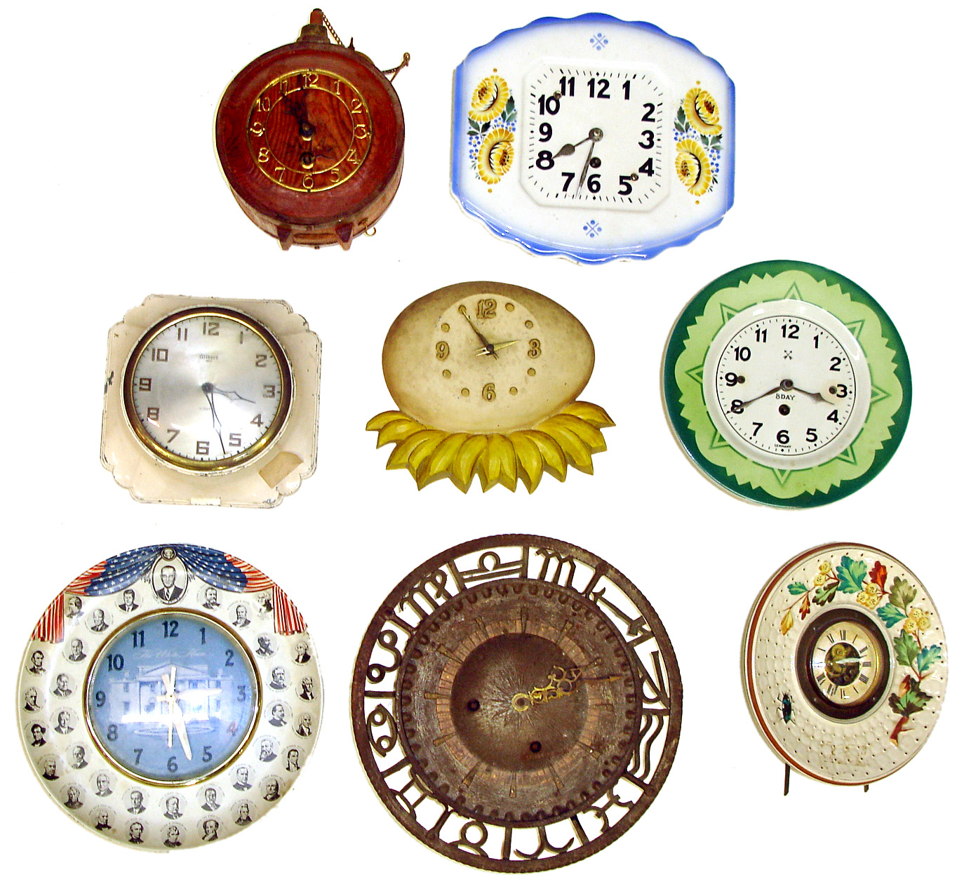 Eight novelty wall clocks. Includes Presidential plate with LBJ on top, colorful plate with visible movement, Hamburg-American, and heavy cast metal with Asian (?) hour symbols. — Antique Clocks Price Guide