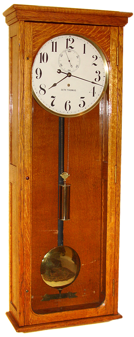 Seth Thomas Clock Co., Thomaston, Conn., "Regulator No. 70" wall clock 8 day time only weight driven movement in oak case with painted metal dial, 1913 — Antique Clocks Price Guide