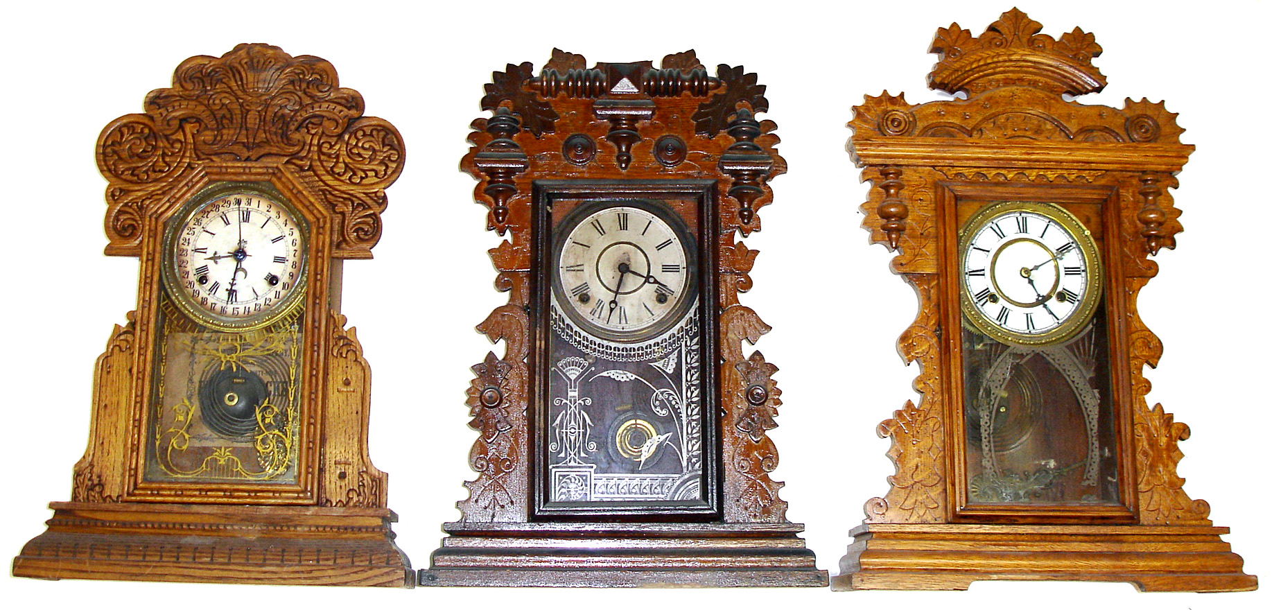Three oak Connecticut 8 day parlor clocks. Bold pressed and carved ornaments, patterned glasses, fancy pendulums. Calendar model is a Waterbury. Tallest is 24" high. — Antique Clocks Price Guide