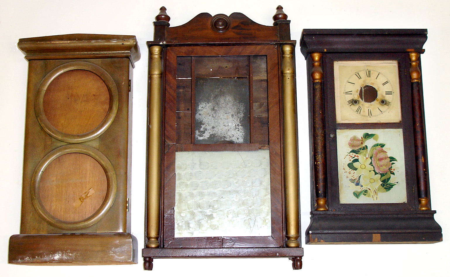 Three Connecticut clock cases (no movements). Smallest is Seth Thomas with label, glasses and dial. Middle original held a double dial calendar clock. Largest, column and splat with old mirror tablet, contained wooden works and is 32" tall. — Antique Clocks Price Guide