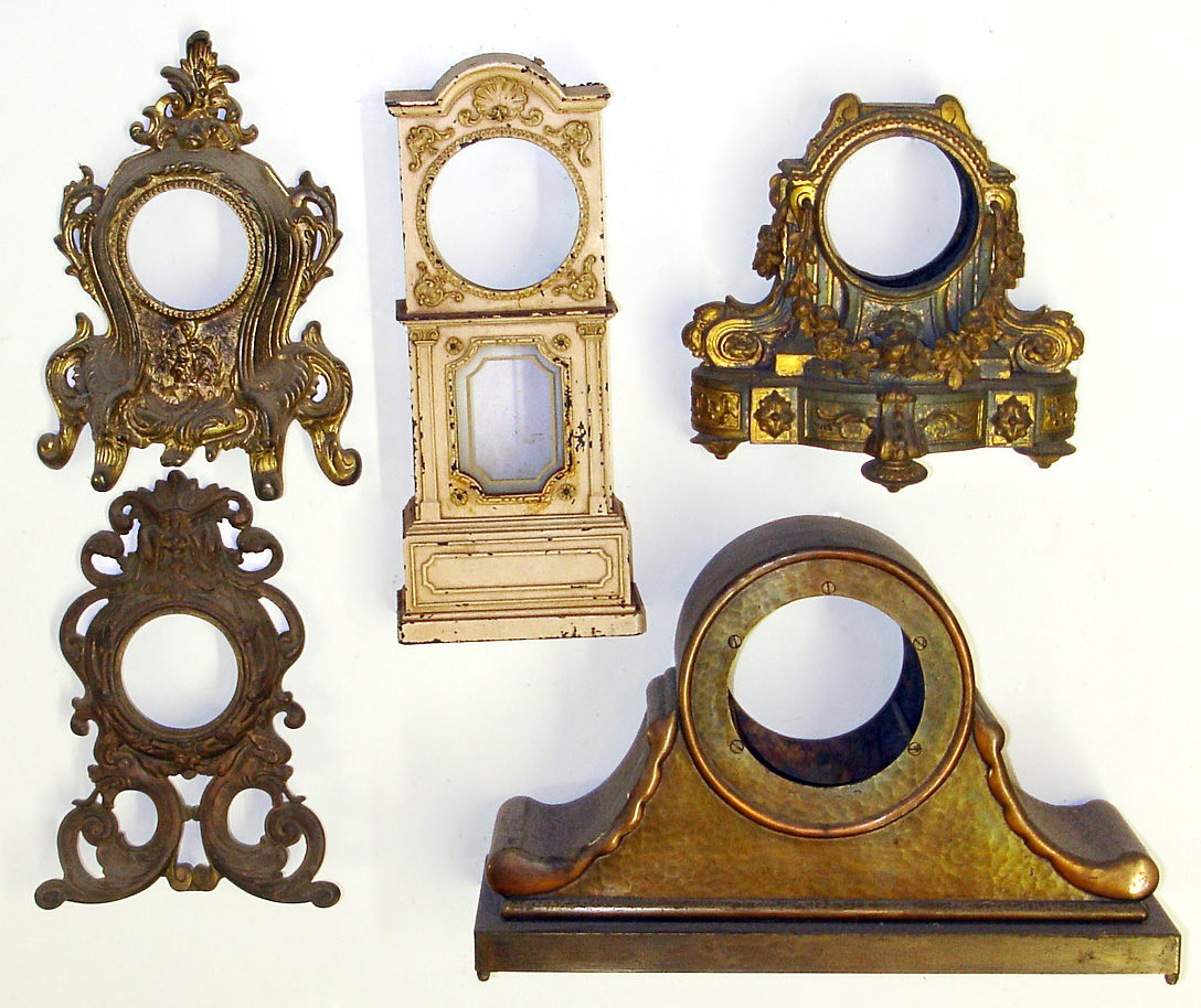 Five cast metal clock cases (no movements). Heavy and detailed castings including two novelties, large bronzed tambour and mini long case 14" tall. — Antique Clocks Price Guide