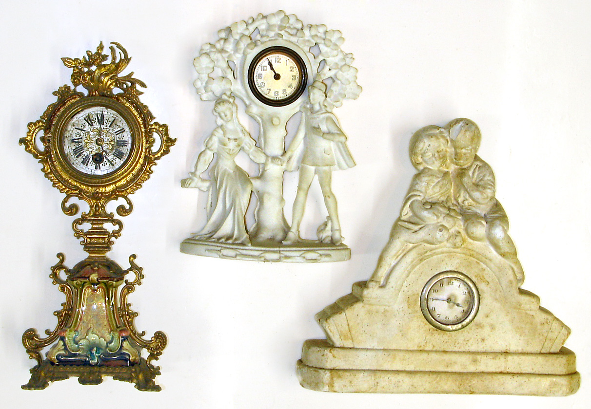 Three Continental novelty clocks. Two are white plaster castings with small pin pallet movements. Largest polychrome heavy cast metal has a quality Lenzkirch time only movement with tic-tac pendulum, 14" tall. — Antique Clocks Price Guide