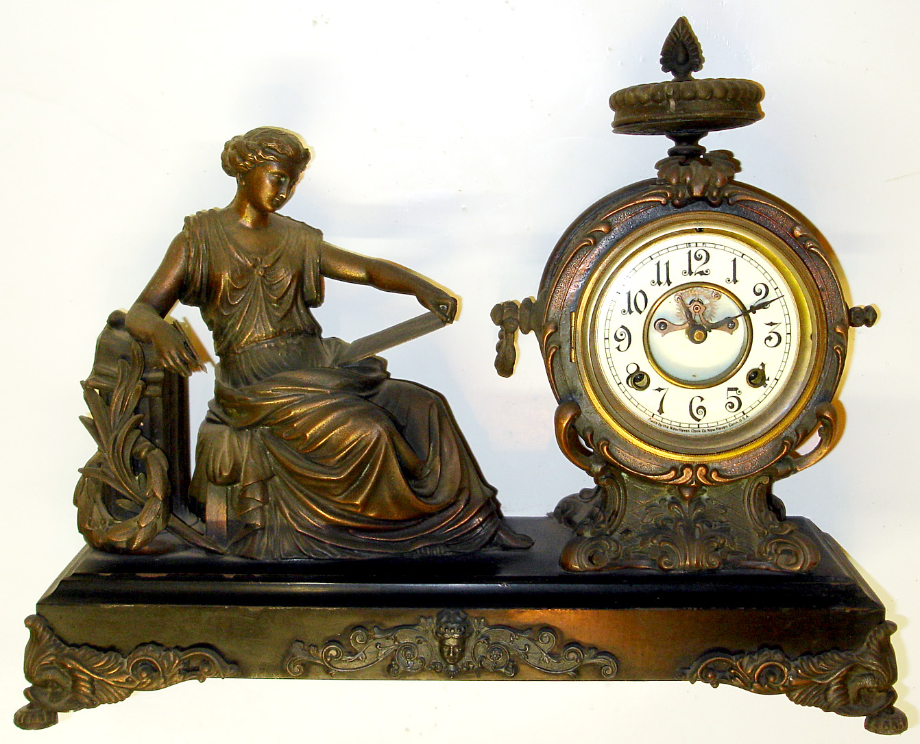 New Haven "Clotho" cast metal 8 day figural mantel clock, c1900. — Antique Clocks Price Guide