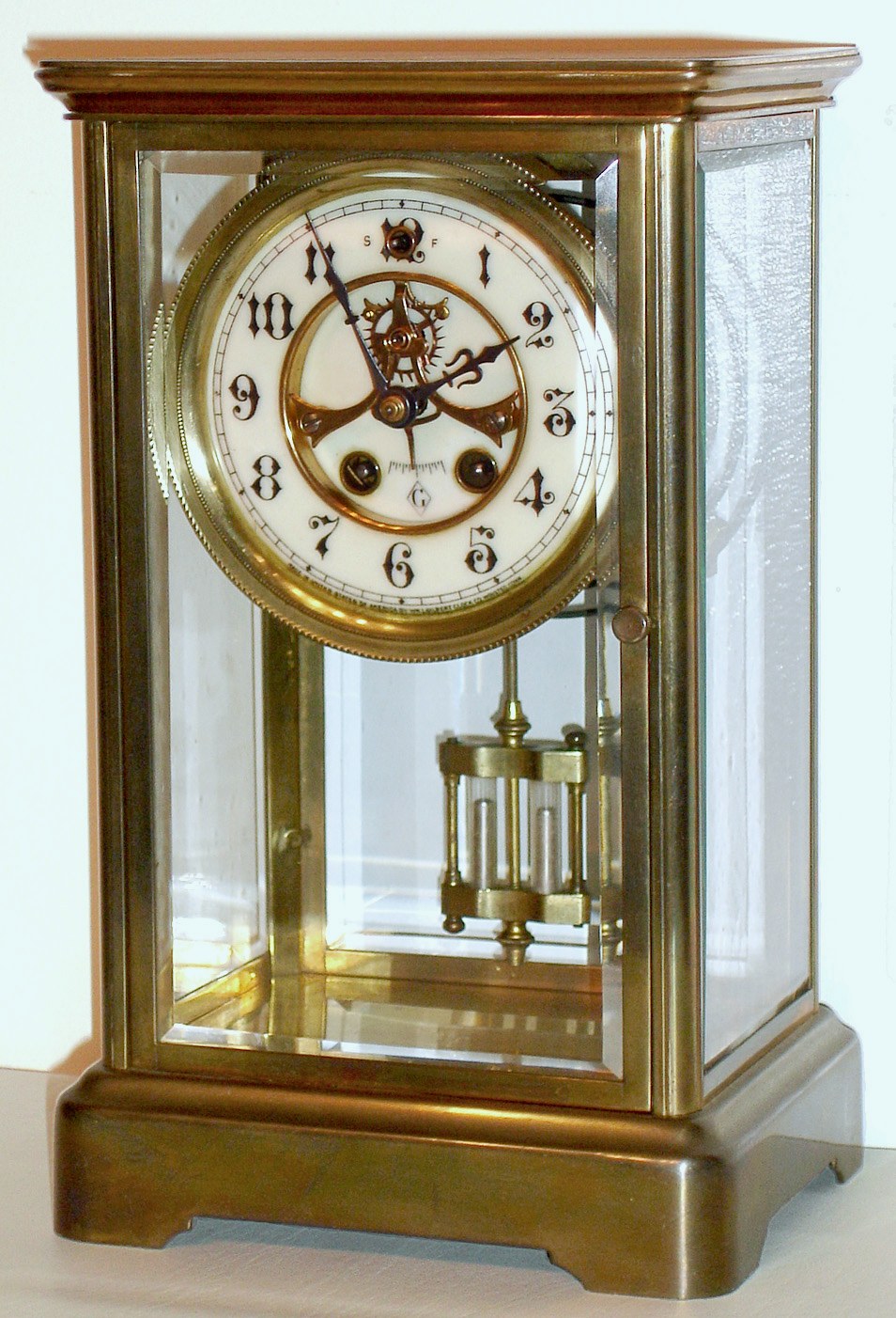 William L. Gilbert Clock Co., "Vista", 8 day time/strike brass and glass crystal regulator, c1913 — Antique Clocks Price Guide