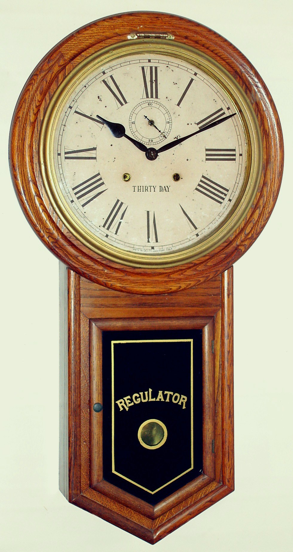 Waterbury Admiral oak 30 day time only wall clock, c1906. — Antique Clocks Price Guide