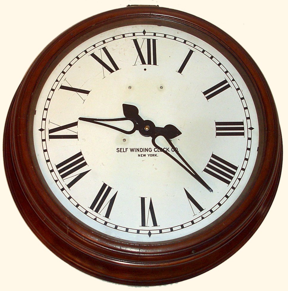 Self Winding Clock Co., New York, "Gallery 18 Inch" wall clock time only pendulum regulated movement powered by two dry cell batteries in cherry finished case with painted metal dial, c1890 — Antique Clocks Price Guide