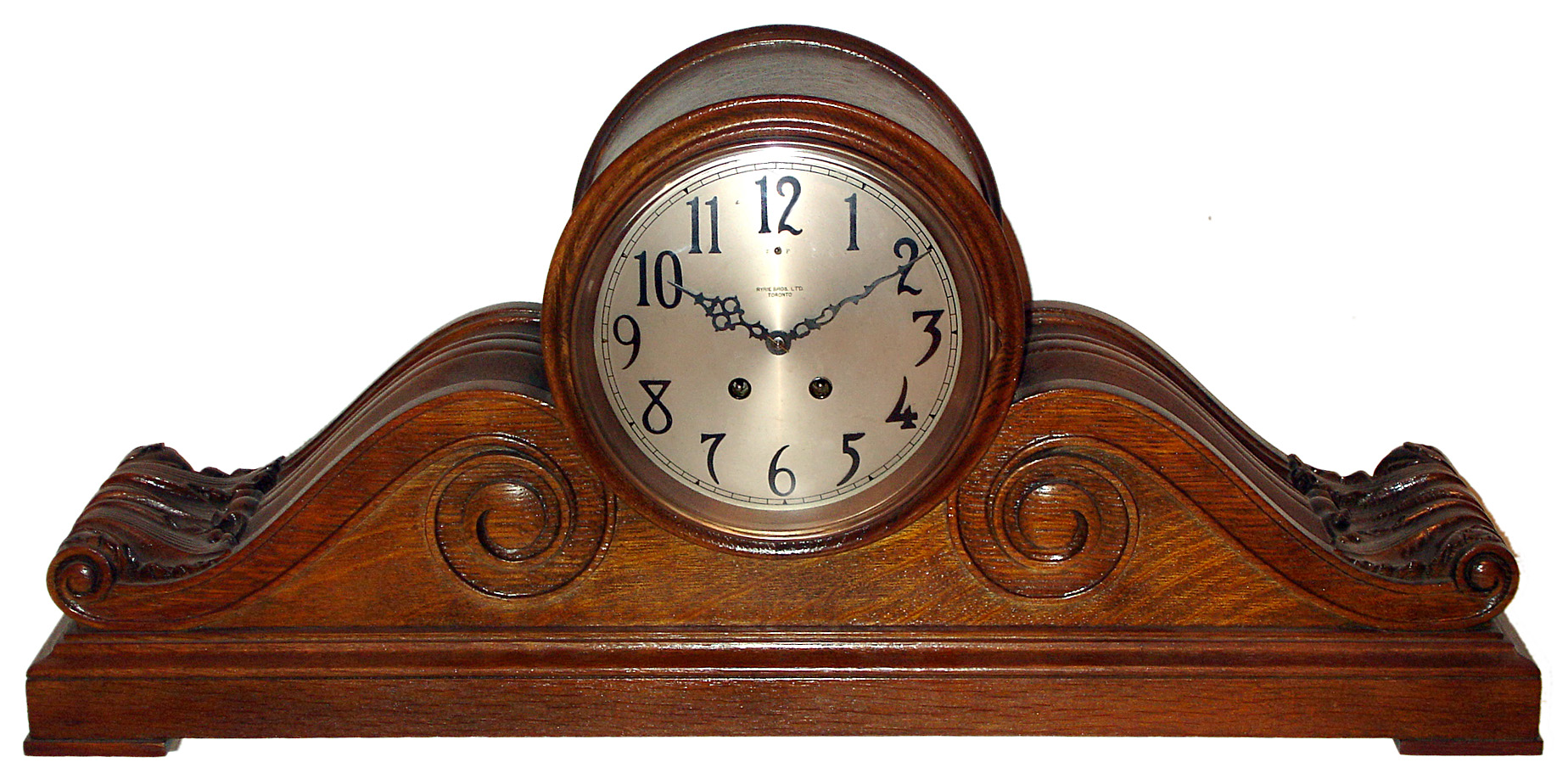 Seth Thomas Clock Co., Thomaston, Conn., manufactured for "Ryrie Bros. Ltd Toronto" oversize "Tambour" mantel clock 15 day time and gong strike spring driven movement in carved oak case with silvered metal dial with raised brass numerals, c1915 — Antique Clocks Price Guide