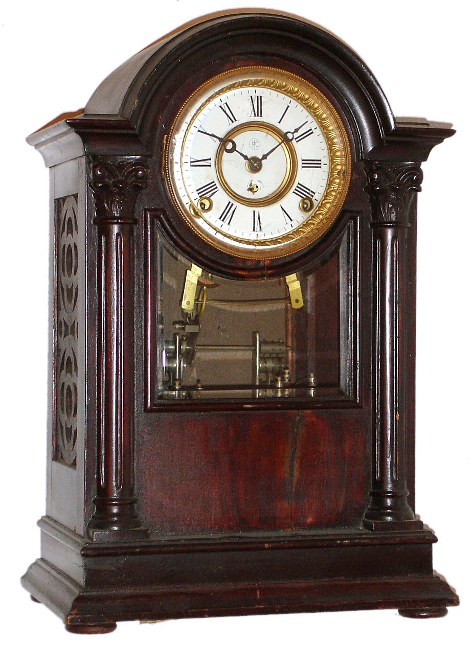 F. Kroeber Clock Co., New York mantel clock with 8 day time and 6 bell strike spring driven movement in mahogany case with beveled glass and white enamel dial, c1898 — Antique Clocks Price Guide