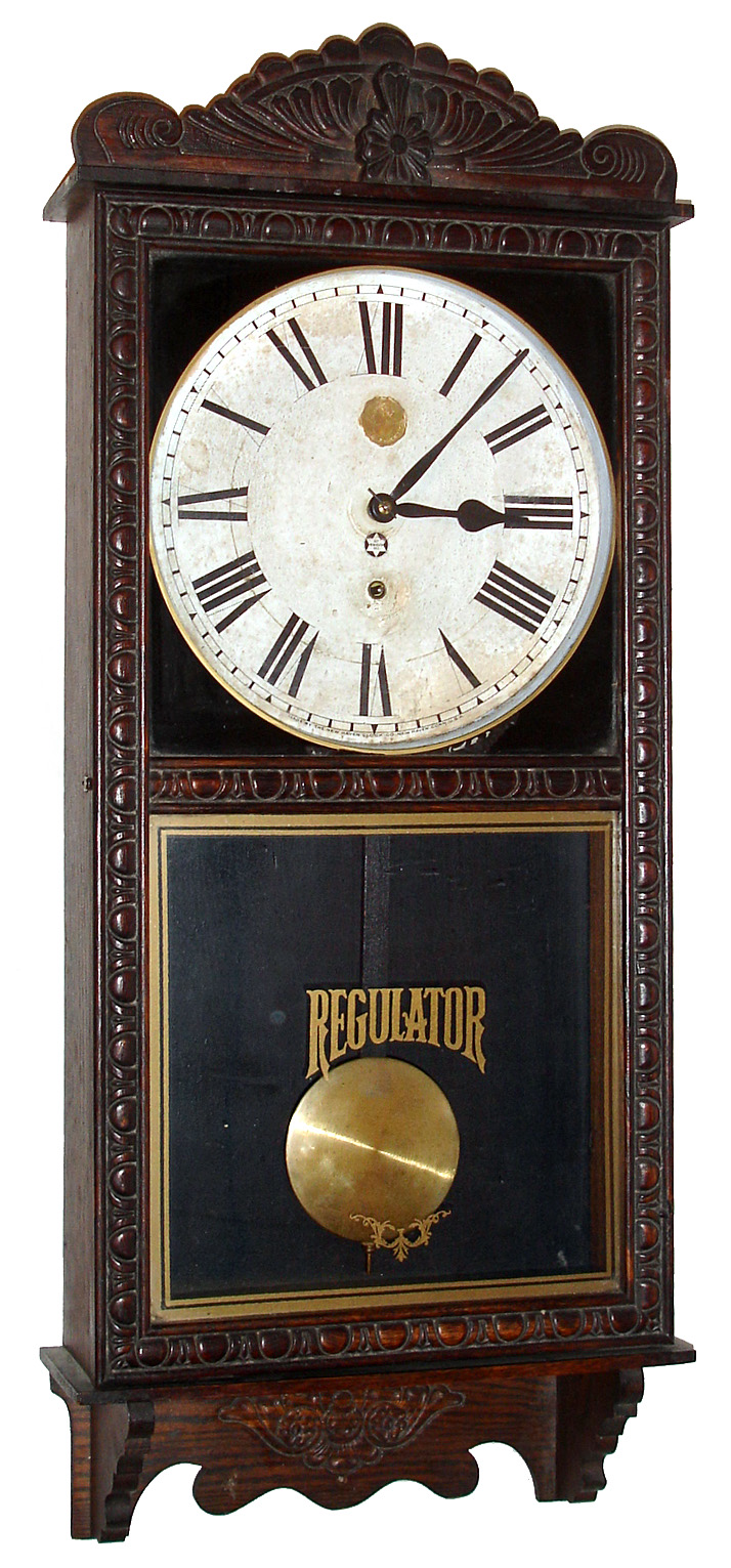 New Haven Clock Co., New Haven, Conn., "Tampa" store regulator wall clock 8 day time only spring driven movement in an embossed oak case with papered metal dial, c1910 — Antique Clocks Price Guide