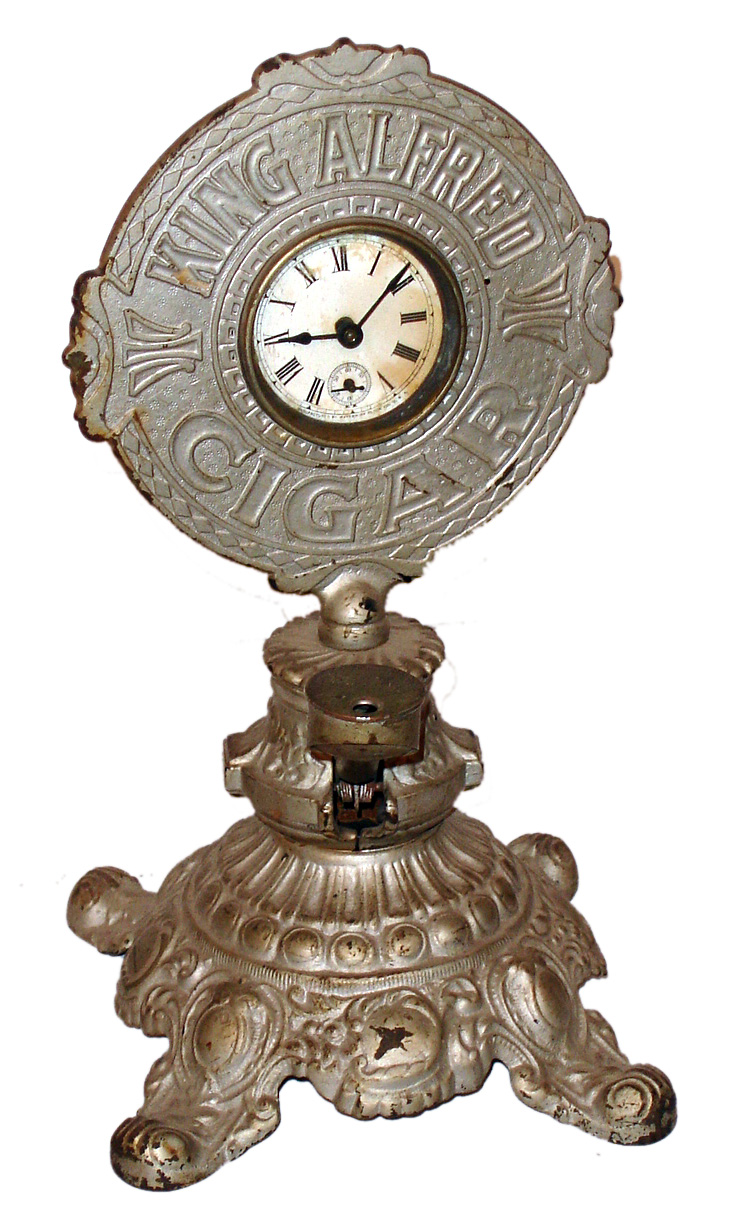 Advertising clock for King Alfred Cigars, standing cast iron cigar cutter inset with 30 hour spring driven movement and papered dial by Waterbury Clock Co., Waterbury, Conn., c1910 — Antique Clocks Price Guide