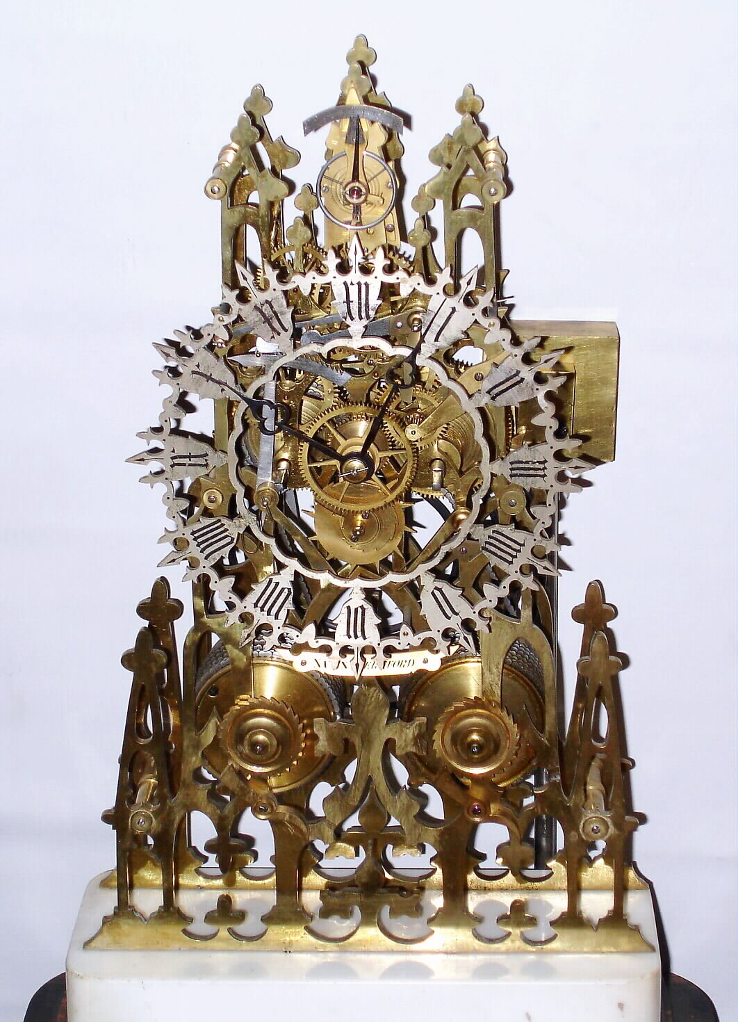 English Skeleton Clock 2-fusee, striking on a gong, attributed to Wm F. Evans of Handsworth (near Birmingham), movement with a vertical platform/lever at the top of the front plate, the clock on a rectangular marble block, mounted to a movement veneered base, with a larger rectangular dome of the period on a still larger veneered / inlaid base, c1865 — Antique Clocks Price Guide