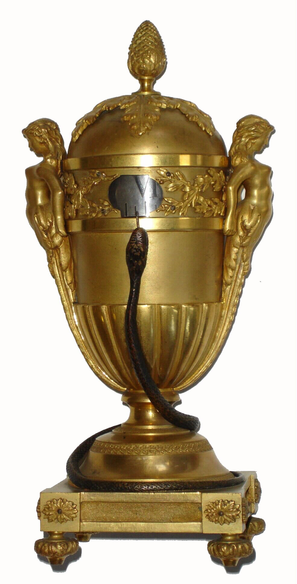 French, Annular dial timepiece, in a brass case with bronze serpent coiled 'round the base and pointing to the time ring with his tongue. Single silvered brass time ring shows the hours. Winding, setting and regulation are accomplished by removing the domed top, which is flanked by two female caryatids. A button in the rear can be pulled gently to re-start the balance if movement has wound down, c1875 — Antique Clocks Price Guide