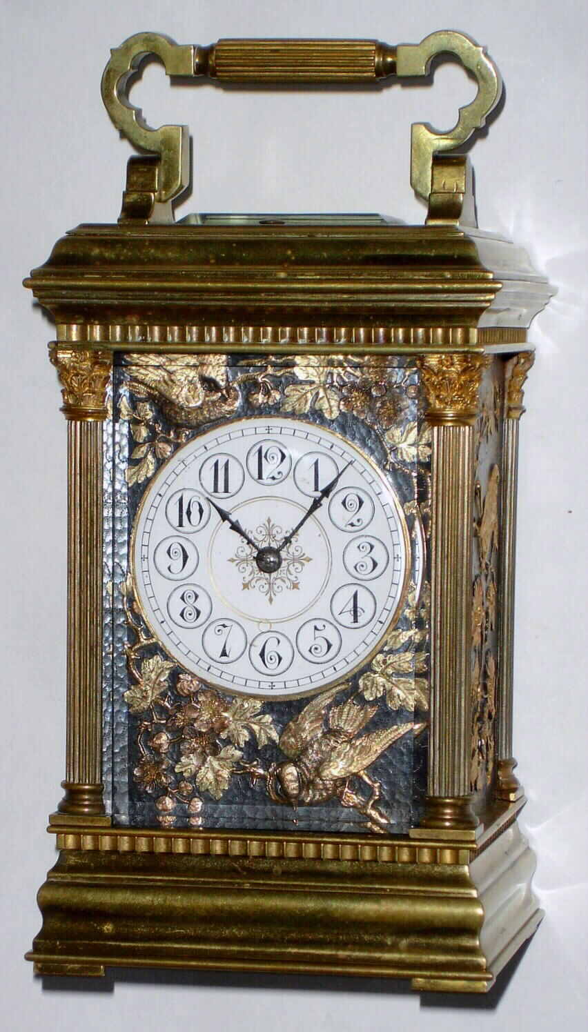French, Brass Cased Carriage clock, Anglaise Riche case with Corinthian columns, time, strike and repeat, with aviary panels to the sides plus the dial mask, birds and flowers cast / pressed into the panels and then carefully chased and gilded, c1900 — Antique Clocks Price Guide