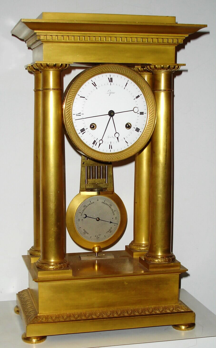 French, Signed Lepine, 4 column Empire style mantel regulator, ormolu case and with pinwheel, 30 day movement and with a compensating grid pendulum with unique temperature variation scale on the front of the pendulum bob, showing from zero change (at top) to a max of plus or minus 40 degrees (at the bottom). Wording is in French (Froid . de Chaud). The pendulum with knife edge suspension, and the dial showing center seconds, the escape wheel having 60 pins and rotating once per minute, c1825 — Antique Clocks Price Guide