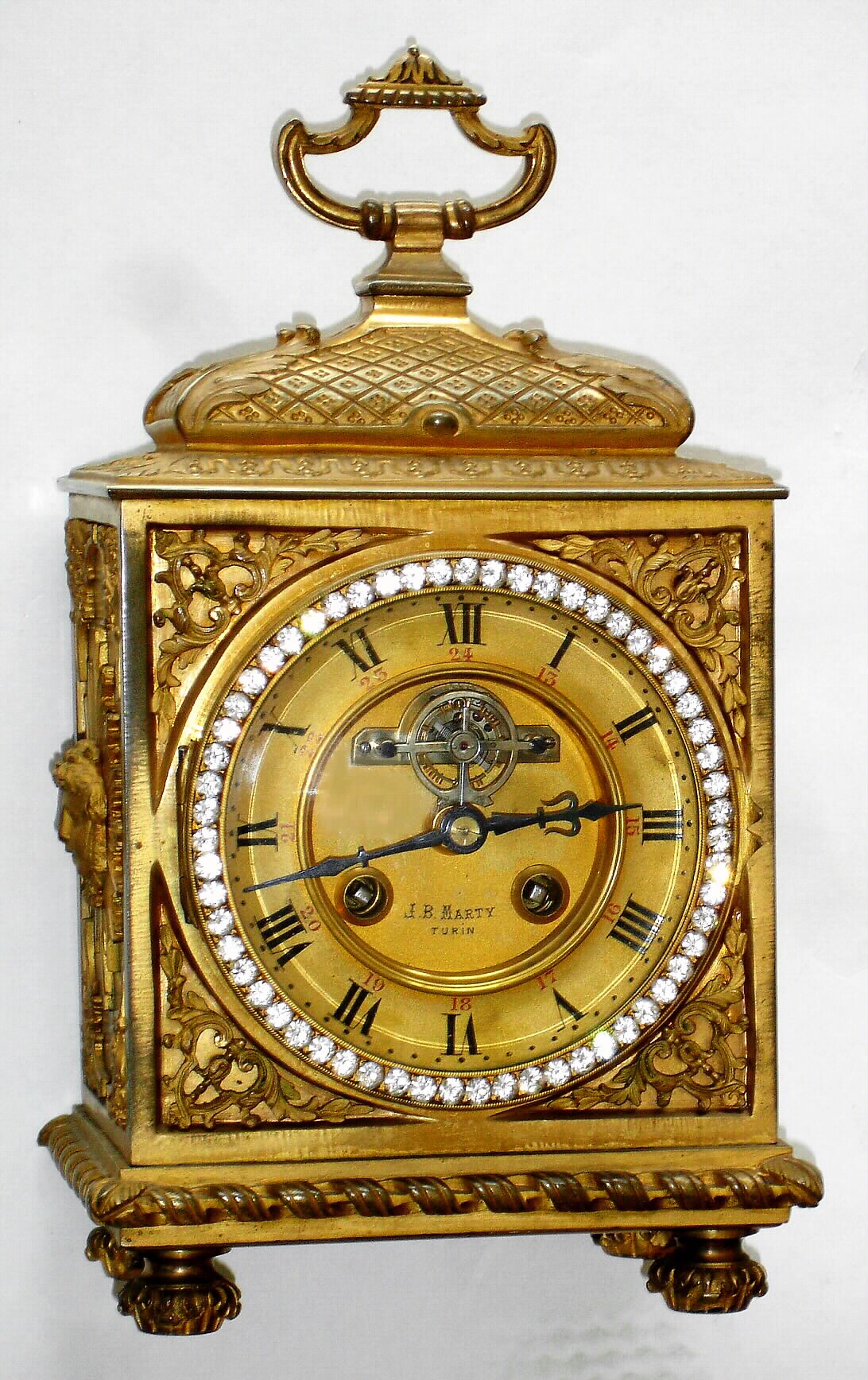 French, Desk clock in bronze/ ormolu, in the style of a Pendule d'officer, and with open escapement on the dial, 8-day, gong striking, and with the retailer's name, "J. B. MARTY, Turin" showing clearly in the dial center. — Antique Clocks Price Guide