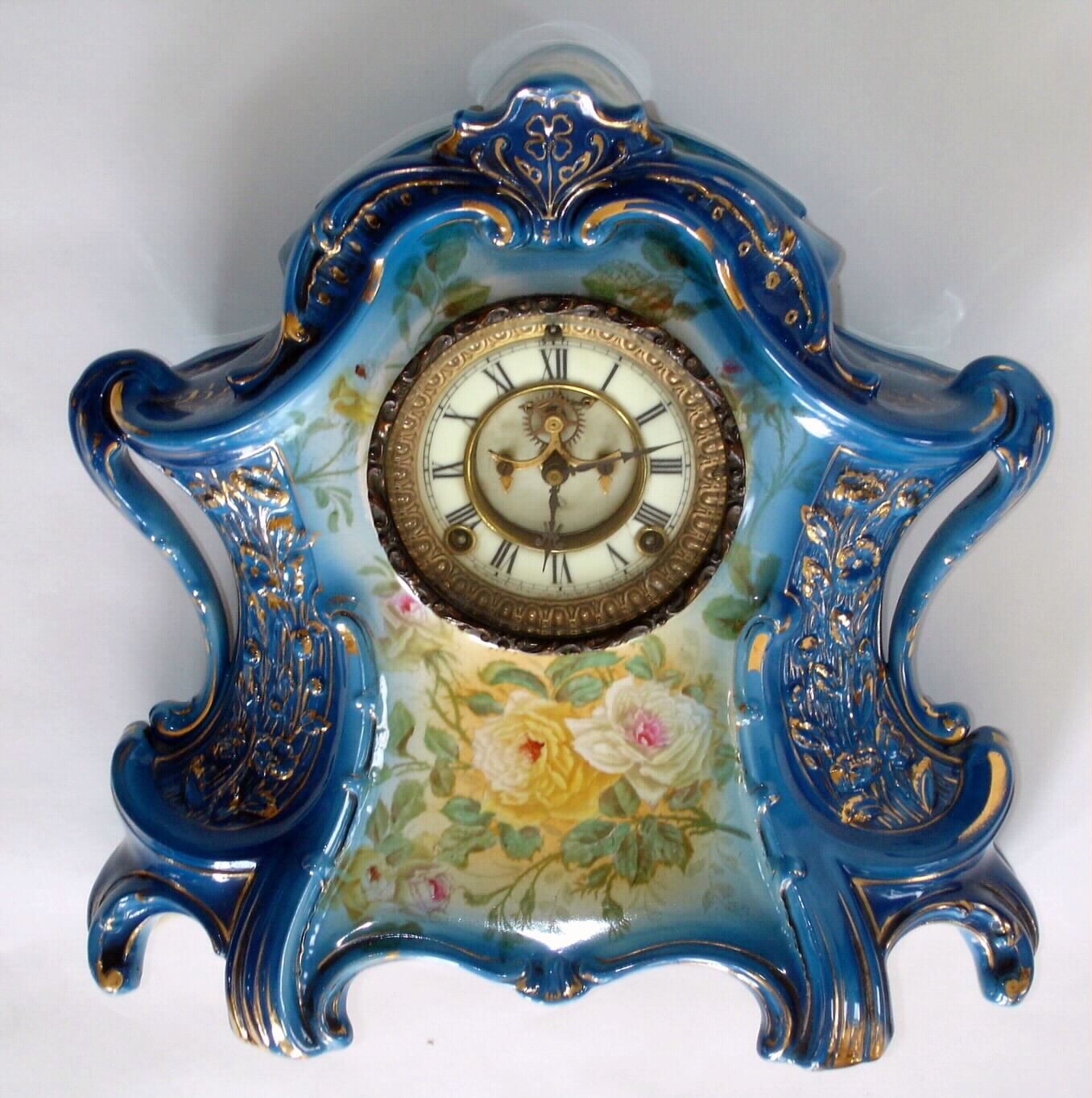 Ansonia Clock Co., Royal Bonn "La Layon" porcelain china clock in medium blue with yellow floral accents and open escapement dial, c1900 — Antique Clocks Price Guide