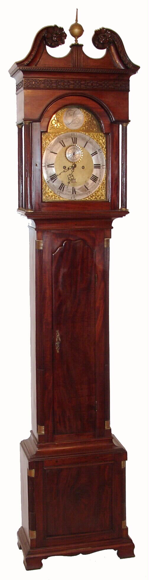 Benjamin Chandlee, Nottingham, (PA), a Chester County brass dial, bell strike movement, C.1770 associated with a central Delaware mahogany case with scalloped top door, reeded side columns w/ simple brass capitals, a broken arch hood and deeply carved rosettes, C.1795, 8-day, weight driven. — Antique Clocks Price Guide