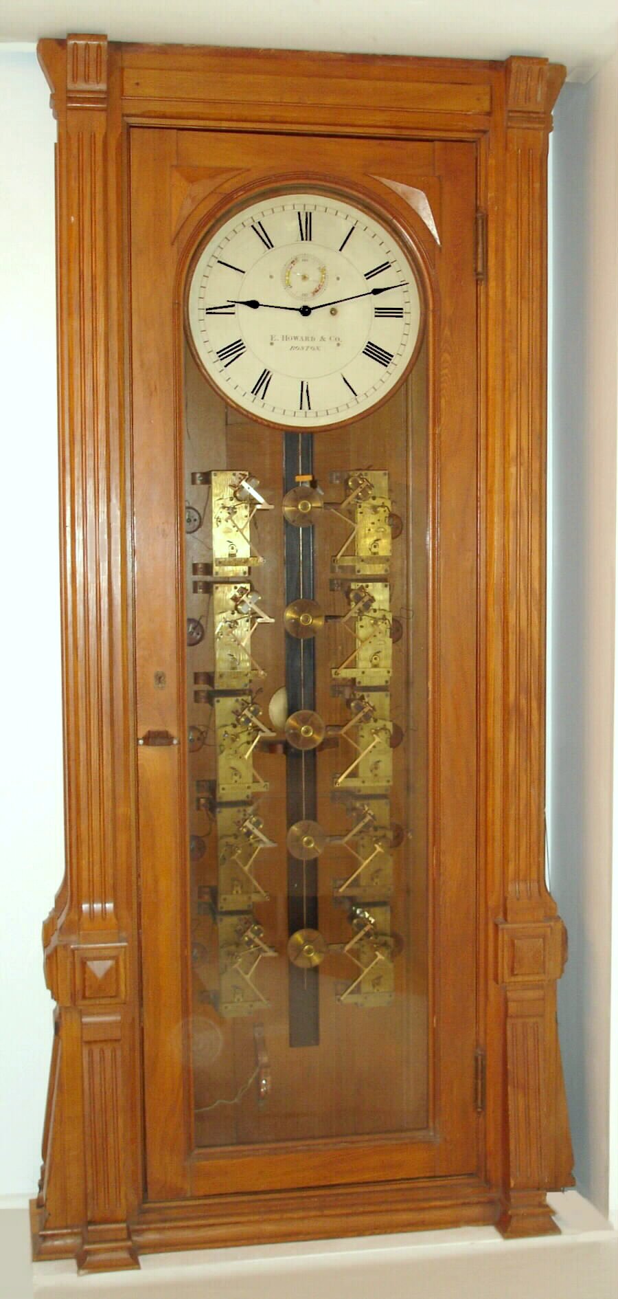 E. Howard and Co., Boston, "Watch Clock For 12 Watchmen" as pictured in the Howard 1888 catalog, in a golden oak case, and with 20" dial and their largest regulator movement, measuring 8" x 11", c1890 — Antique Clocks Price Guide