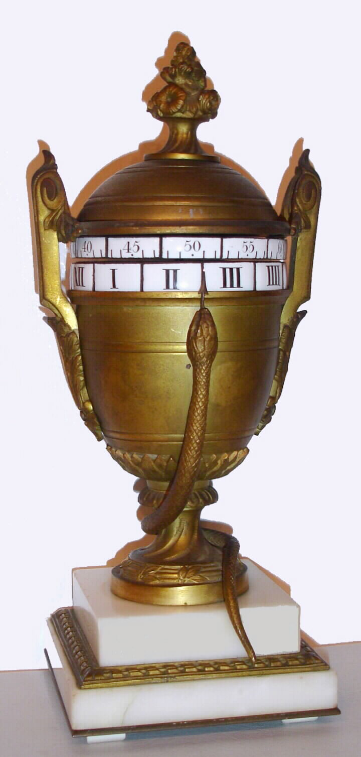 French, ormolu and white marble urn form with a snake pointer annular dial with a platform lever escapement driving two porcelain cartouche time rings, top is minutes and bottom hours, c1875 — Antique Clocks Price Guide