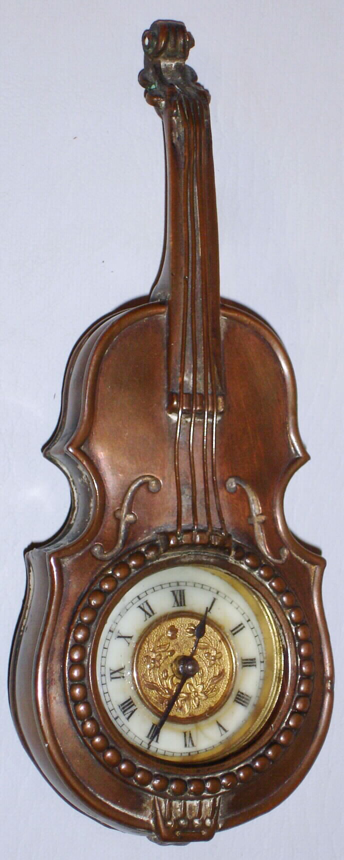Ansonia Clock Co., 30-hour brass musical instrument novelty timepiece. c. 1904. This appears to be a part from a timepiece named the "Violone" this was made up mounted on a stand. — Antique Clocks Price Guide