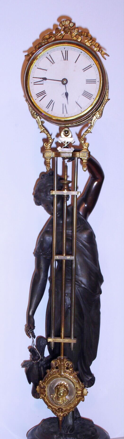 Ansonia Clock Co., New York, "Huntress Swing", 8 day swinging arm timepiece, the movement contained within the canister, commonly called the "Tin Can" arm, c.1885. — Antique Clocks Price Guide