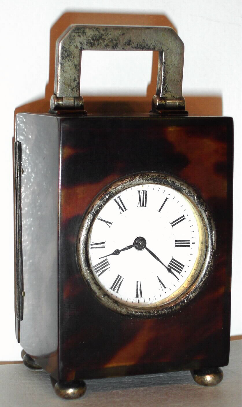 French, 8 day miniature carriage timepiece in a tortoise shell case with London 1912 hallmarked sterling silver handle, feet, latch and bezel, c1900 — Antique Clocks Price Guide