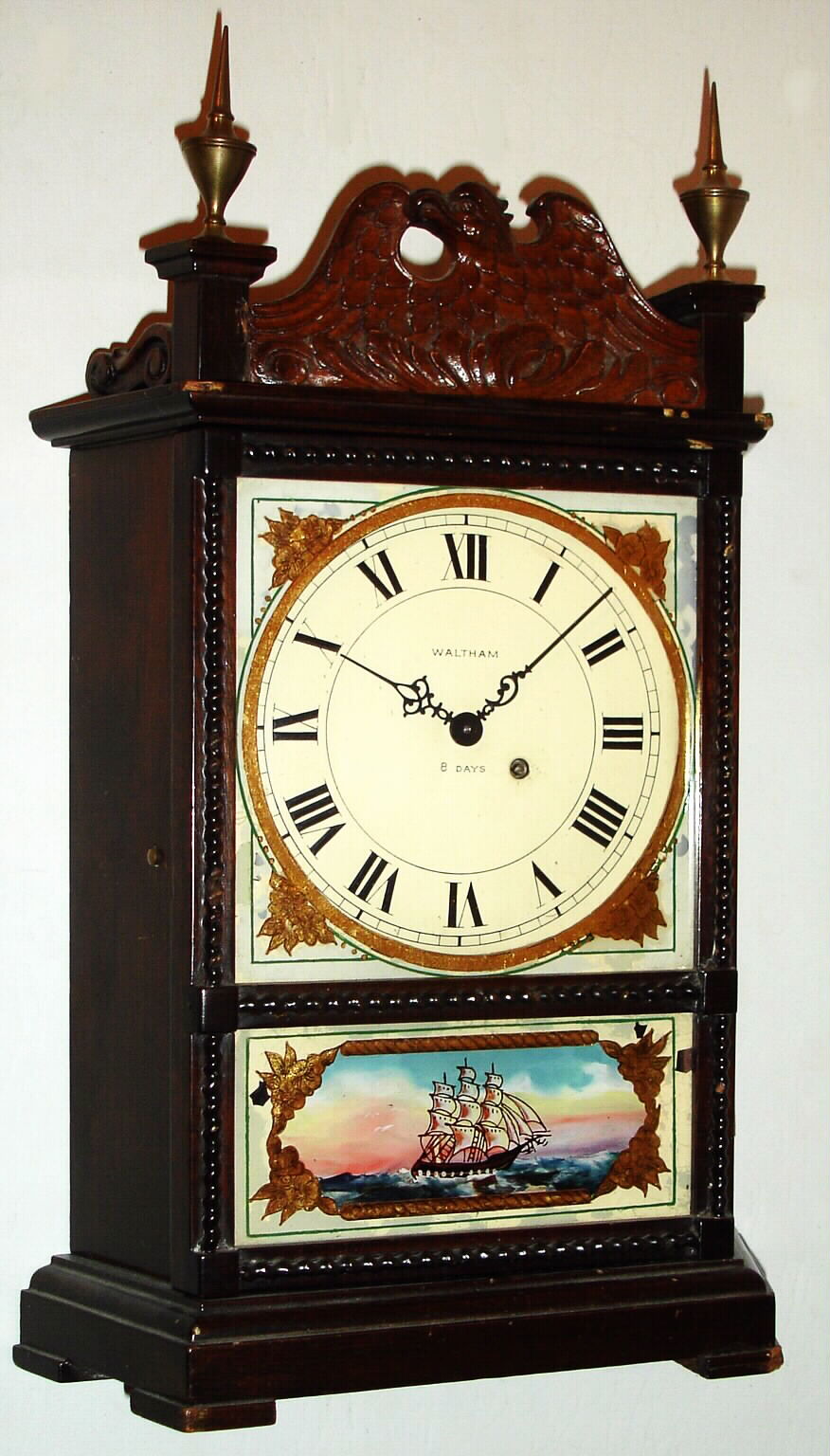 Waltham Watch Co., Waltham, Mass., miniature mantel clock 8 day spring driven movement with lever escapement in mahogany case with eagle splat and reverse painted tablet, c1930 — Antique Clocks Price Guide