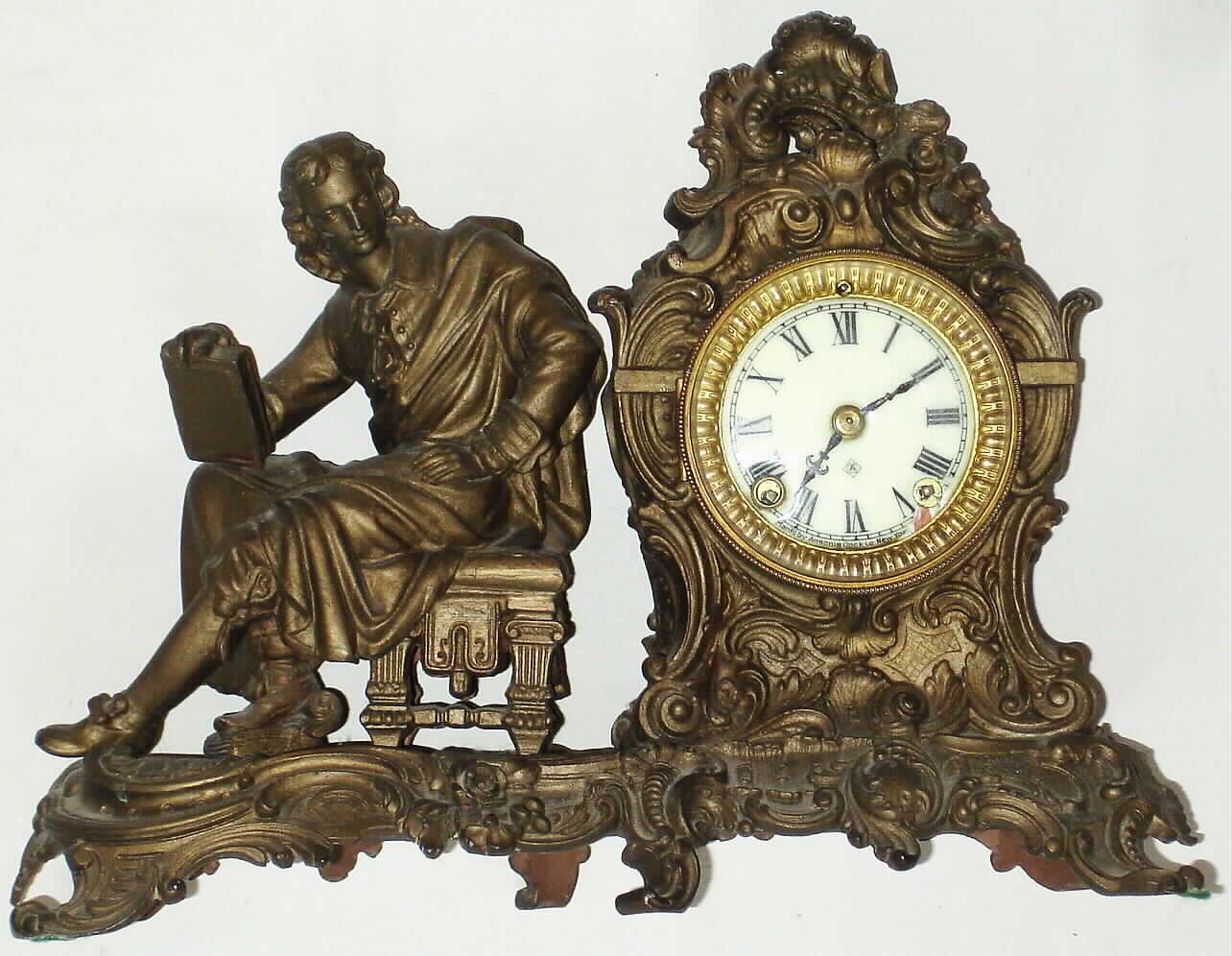 Ansonia Clock Co., New York, "Racine" figural mantel clock with 8 day time and strike spring driven movment in bronze finish cast metal case, c1901 — Antique Clocks Price Guide