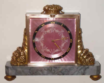 Gubelin, Lucerne, Switzerland, ormolu and marble time and strike desk clock, jeweled lever escapement, rear wind, striking on internal coiled wire gong with pink guilloche enamel Roman numeral dial, c1920 — Antique Clocks Price Guide