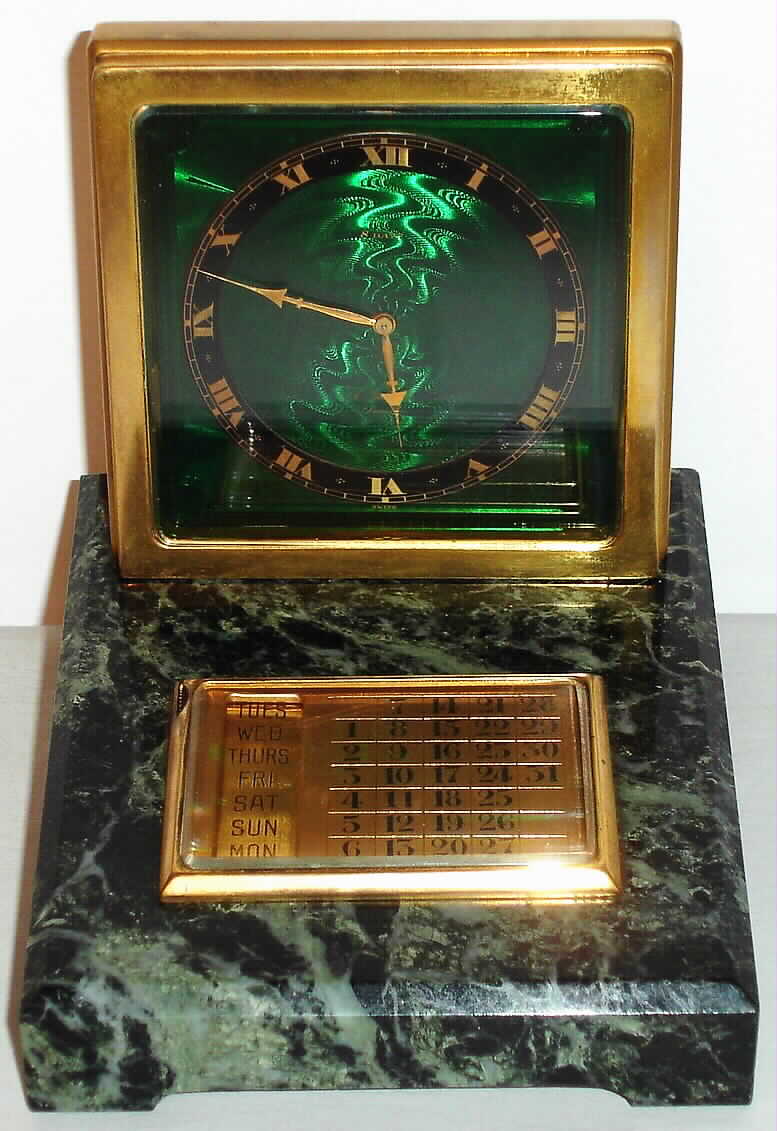 E. Gubelin, Lucerne, Switzerland Art Deco desk clock 8 day spring driven movement in gilt frame with green guilloche enamel dial with Roman numeral black chapter ring on black and green marble base with separate manually operated calendar, c1920 — Antique Clocks Price Guide