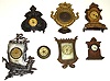 Seven cast-metal novelty clocks. Includes Meridan silver-plate sailing ship, Pennsylvania Fire Insurance Co. 1825-1925, French silver-dial strut, etc.