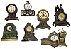 Seven metal-case clocks. Includes 2 Darche (battery alarm), 2 Seth Thomas long alarms, a "Maine" marine novelty, green rocks novelty, and cast iron figural.