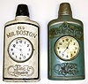 Two Gilbert "Old Mr. Boston" clocks. Green and white versions. Spring movements, time only, 21" tall.