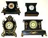 Four black iron 8-day mantel clocks. 1 Ansonia, 1 New Haven, smallest has unusual small movement with under slung strike train, tallest is 14" high.