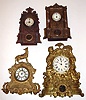 Four 8-day American iron fronts 2 gold figurals, 1 with U.S. Clock Co. dial in N. Muller No. 21 case. Largest is 20" high.